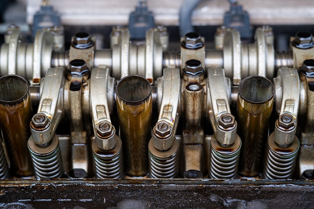 close up arm valve rocker of single over head camshaft engine.car maintenance checking and adjusting valves clearance.