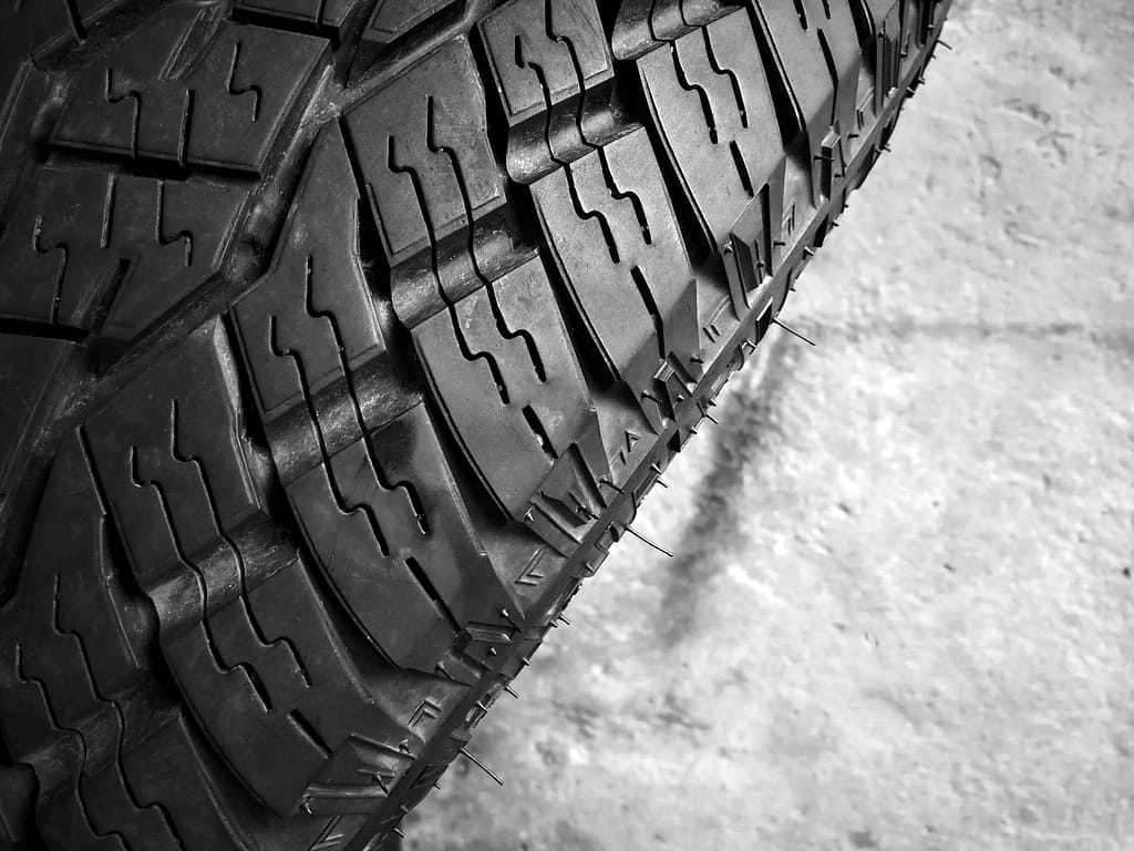 part of mud all terrain truck tire closeup on white background
